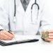 a doctor holding some cannabis and writing a prescription